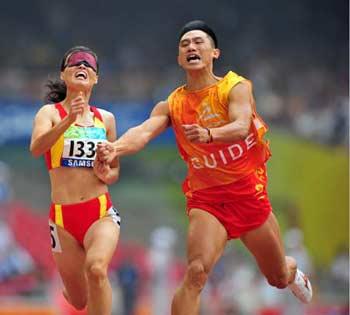 China's Wu Chunmiao (L) runs with the guide during the final of the women's 100m T11 of the Beijing 2008 Paralympic Games, at the National Stadium, also known as the Bird's Nest, in Beijing, China, Sept. 9, 2008. Wu claimed the title of the event with a time of 12.31 seconds.(Xinhua Photo)