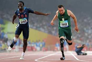 "Blade Runner" Oscar Pistorius (R) from South Africa crosses the finish line ahead of Jerome Singleton of the United States during the final of men's 100m T44 of the Beijing 2008 Paralympic Games, at the National Stadium, also known as the Bird's Nest, in Beijing, China, Sept. 9, 2008. Pistorius claimed the title of the event with a time of 11.17 seconds.(Xinhua/Li Ga)