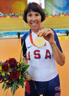 Fifty-two-year-old Barbara Buchan of the United States displays her gold medal in the awarding ceremony of women's individual pursuit(LC3-4/CP3) of the Beijing 2008 Paralympic Games cycling track event on Sept. 10, 2008. Buchan won gold medal in the event with 4 mins 15.848 secs.(Xinhua/He Junchang)