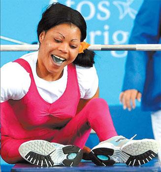 Nigerian powerlifter Lucy Ejike smiles after breaking the world record of 130kg to win the gold.