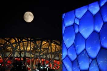 A nearly full moon over the National Stadium or better known as the Bird's Nest in Beijing on early September 14, 2008, which is now hosting the athletic competition for the 2008 Beijing Paralympic Games. Paralympians in Beijing will get a taste of China's Mid-Autumn Festival, which falls on September 14 this year.(Photo Source: China Daily/Agencies)