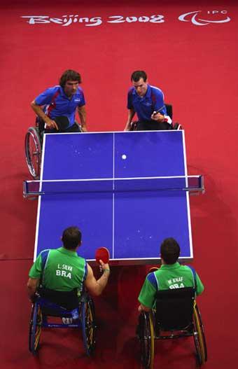 Jean-Phillippe Robin (blue, R2) serves. Jean-Philippe Robin and Florian Merrien of France beat Luiz Algacir Silva and Welder Knaf of Brazil 3-1 in the Men's Table Tennis Team Class 3 final at the Beijing 2008 Paralympic Games on September 15, 2008, claiming the gold medal. [Getty Images]