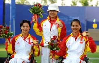 China's Gao Fangxia(C), Xiao Yanhong(L) and Fu Hongzhi display medals on the podium during the awarding ceremony of women's team recurve-open of the archery event at the Beijing 2008 Paralympic Games in Beijing, China, Sept. 15, 2008. China defeated South Korea 205-177 and won the gold medal.(Xinhua Photo)