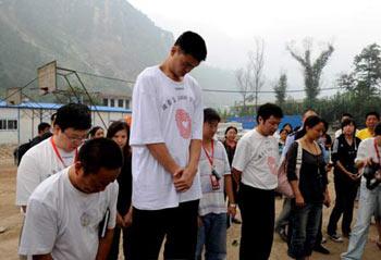 Chinese basketball star Yao Ming mourn for the victims of the Wenchuan quake in front of the ruins of the Beichuan Middle School in Beichuan County, Sichuan Province, southwestern China, Sept. 14, 2008. Yao Ming made a charity tour of southwest China's Sichuan Sunday which was devastated by a deadly earthquake on May 12, attended the foundation ceremony of a hope primary school in Guangyuan City and mourned for the quake victims at the ruins of the Beichuan Middle School. (Xinhua Photo)