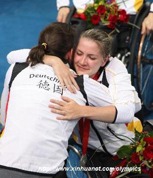 Player of the Germany hugs teammate in the awarding ceremony of women's wheelchair basketball at the Beijing 2008 Paralympic Games in Beijing, September 15, 2008. Germany was defeated by USA 38-50 and won the silver medal. (Xinhua/Meng Yongmin)