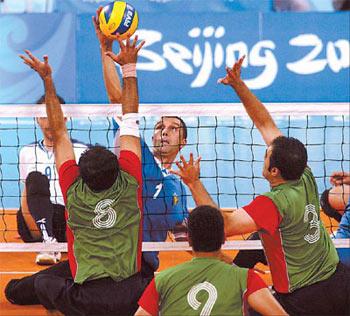 Iran's Jalil Eimery (No 8) and Reza Peidayesh (No 3) try to block a ball during the men's sitting volleyball gold medal match against Bosnia & Herzegovina. Iran won 3-0. [Agencies]