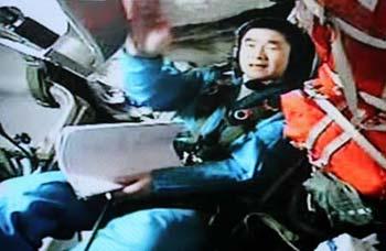 Blue-suited Chinese astronaut Liu Boming is on duty in the cabin of the Shenzhou VII spacecraft in this frame grab taken on the morning of September 26, 2008. Astronauts aboard the Shenzhou VII spacecraft, China's third manned spaceship, began to unpack and assemble the indigenous Feitian extra-vehicular activity (EVA) suit at 10:20 am Friday in preparation for China's first spacewalk.[CFP]
