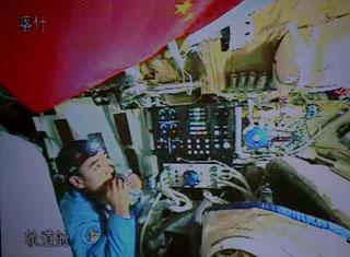 Chinese taikonaut Zhai Zhigang tries a bite on his food in the orbit module of the Shenzhou-7 spacecraft, in this video grab taken on Sept. 26, 2008. The Shenzhou-7 spacecraft, which blasted off at 9:10 p.m. Thursday at the Jiuquan Satellite Launch Center in northwest China's Gansu Province, has functioned well as planned. (Xinhua/Zha Chunming) 