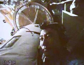 The video grab taken on Sept. 27, 2008 at the Beijing Space Command and Control Center in Beijing, China, shows Chinese taikonaut Zhai Zhigang checks the door of the orbital module. Zhai Zhigang began the activities of China's first spacewalk on Saturday afternoon.(Xinhua/Chen Jianli)