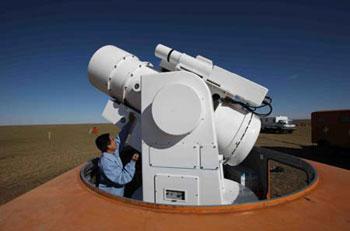 A staff member operates an optical record machine at the main landing field of the Shenzhou-7 spacecraft in Siziwang Banner (county), north China's Inner Mongolia Autonomous Region, where the spacecraft is expected to land as it returns to the earth, on Sept. 26, 2008.(Xinhua Photo)