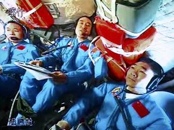 The video grab taken at the Beijing Space Command and Control Center on Sept. 27, 2008 shows Chinese taikonauts (L-R) Jing Haipeng, Zhai Zhigang and Liu Boming talk on the spacecraft Shenzhou-7 with Chinese President Hu Jintao who is in Beijing, capital of China, Sept. 27, 2008.(Xinhua Photo/Chen Jianli)