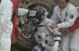Astronauts exit re-entry capsule