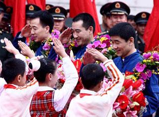 Young pioneers present bouquets to Chinese astronauts Zhai Zhigang, Liu Boming and Jing Haipeng at the space program headquarters in Beijing's north suburbs, China, on Sept. 29, 2008. The three Chinese astronauts who successfully completed a space journey Sunday came back to Beijing Monday morning. (Xinhua/Chen Jianli) 