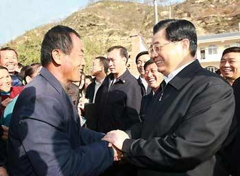 Undated photo shows General Secretary of the Communist Party of China (CPC) Central Committee Hu Jintao (R), who is also Chinese President and Chairman of the Central Military Commission, chats with a villager during his visit to Hougoumen Village of Yanhewan Town in Ansai County of Yan'an City, northwest China's Shaanxi Province. Leaders of the CPC have visited nine places in the country to find out how well the Party members, officials and common citizens were learning and implementing Scientific Outlook on Development. It is considered an important guiding principle for China's economic and social development.(Xinhua Photo)
