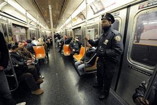 A New York police officer rides a subway train, in New York Wednesday Nov. 26, 2008.(AP Photo/Richard Drew)