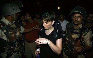 Indian security forces lead a released hostage from Nariman House in Mumbai.(AFP/Prakash Singh)