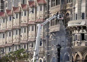 Firefighters make efforts in front of the Mumbai Taj hotel in Mumbai, India, on Nov. 29, 2008. The final encounter at the Mumbai Taj hotel ended at about 8:20 a.m. local time Saturday morning, reported local TV channel Headlines Today.(Xinhua Photo)