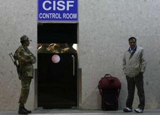 A passenger waits outside the control room of the Central Industrial Security Force (CISF), in charge of airport security, at the international airport in New Delhi December 5, 2008.REUTERS/Adnan Abidi