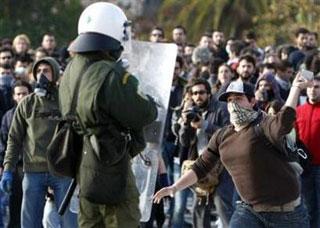 A protester throws a stone at a policeman during riots outside Greece's parliament in Athens, December 12, 2008.(Yiorgos Karahalis/Reuters)