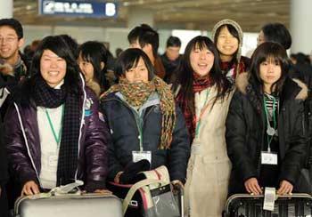 High school students of a Japanese youth delegation arrive at the Beijing Capital International Airport in Beijing, capital of China, Dec. 18, 2008. The 1,000-member-delegation arrived here on Thursday, rounding off this "China-Japan Friendly Exchange Year of the Youth." Breaking into seven small groups, they will respectively visit such cities as Ningbo, Hangzhou, Jinan and Qingdao in the east, Xi'an and Baoji in the west, Shenzhen and Guangzhou in the south and Dalian and Shenyang in the northeast. (Xinhua Photo)