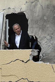 Israeli opposition leader Benjamin Netanyahu inspects a house in Sderot, damaged by a rocket launched from the Gaza Strip. Israel threatened on Sunday to launch a major offensive against the Hamas-ruled Gaza Strip as violence simmered around the impoverished territory days after the end of a truce with the Islamists.(AFP/David Buimovitch)