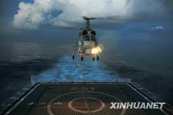 A helicopter conducts a nighttime landing exercise on a Chinese naval ship on Sunday, December 28, 2008.[Photo: Xinhua]