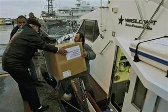 International activists load boxes of medical supplies aboard a boat before setting sail for Gaza from the Cypriot port of Larnaca, Cyprus, Monday, Dec. 29, 2008.(AP Photo/Petros Karadjias)