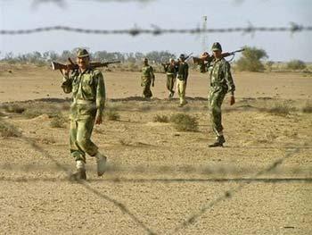 Indian Border Security Force soldiers walk during a patrol along the India-Pakistan border near Bikaner on December 27, 2008. Pakistan on Tuesday called for talks with India to defuse tensions between the nuclear-armed neighbours, as New Delhi denied claims it had moved troops into offensive positions on the border.(AFP/File) 