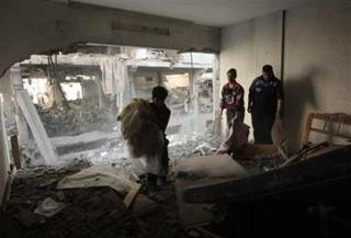 Palestinians survey their damaged house after an Israeli air strike in Gaza January 5,2009.(Mohammed Salem/Reuters)
