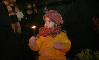 An Irani child holds a candle while praying for the children in Gaza during a rally at the Palestine Square in Tehran, capital of Iran, Jan. 7, 2009. Thousands of Irani people gathered at the square Wednesday night to support the Palestinian people.(Xinhua/Che Ling)