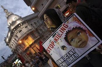 A demonstrator holds a sign during a protest against Israel's military strikes on the Gaza Strip in Asuncion, Paraguay, Friday, Jan. 9, 2009. (AP Photo/Rene Gonzalez) 
