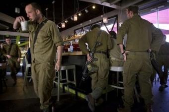 Israeli reservists drink coffee in Yad Mordechai near Israel's border with Gaza, Monday, Jan. 12, 2009.(AP Photo/Sebastian Scheiner)