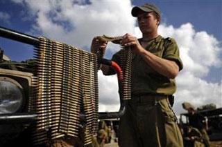 An Israeli soldier hangs up bullets after crossing into Israel from the Gaza Strip January 18, 2009.(Amir Cohen/Reuters)