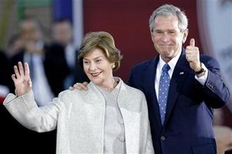 Former President George W. Bush and former first lady Laura Bush wave to the crowd during a 'Welcome Home' rally, Tuesday, Jan. 20, 2009, in Midland, Texas.(AP Photo/Matt Slocum)