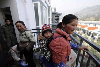 Villagers are seen in their new houses at Qipan village in Xiang'e town of Dujiangyan City, southwest China's Sichuan Province, Jan. 21, 2009. As their homestead was destroyed in the earthquake in May 2008, 80% of 274 families in Qipan village have moved to new houses recently. (Xinhua/Wang Jianhua)