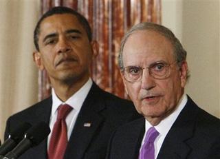 President Barack Obama looks on as Middle East envoy George Mitchell speaks at the State Department in Washington, Thursday, Jan. 22, 2009. (AP Photo/Charles Dharapak)