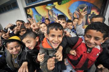 Gaza children pose for photos during their break in the Beit Loliya Boys Elementary School in Gaza city Jan. 24, 2009. Some 200,000 Gaza children returned to school for the first time since Israel‘s offensive. (Xinhua/Zhang Ning)
