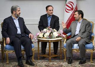 Iranian President Mahmoud Ahmadinejad (R) speaks with Hamas leader Khaled Meshaal with the aid of a translator (C) during a meeting in Tehran, February 1, 2009. (Xinhua/Reuters Photo)