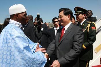 Chinese President Hu Jintao (R Front) is welcomed by his Senegalese counterpart Abdoulaye Wade (L Front) at the airport in Dakar, capital of Senegal, Feb. 13, 2009. Chinese President Hu Jintao arrived in the Senegalese capital of Dakar on Friday for a state visit to promote friendly and cooperative relations between the two countries. (Xinhua/Ju Peng)