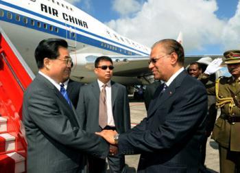 Chinese President Hu Jintao (L Front) shakes hands with Mauritian Prime Minister Navinchandra Ramgoolam greeting him upon his arrival in Port Louis for a state visit Feb. 16, 2009.(Xinhua/Rao Aimin)
