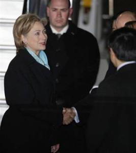 U.S. Secretary of State Hillary Rodham Clinton, left, is welcomed by protocol officers upon her arrival at Haneda international airport in Tokyo, Japan, Monday, Feb. 16, 2009.(AP Photo/Shizuo Kambayashi)