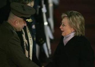 Secretary of State Hillary Clinton is greeted by an unidentified U.S. official upon her arrival at a military airport in Seongnam, near Seoul, February 19, 2009. (Jo Yong-Hak/Reuters)
