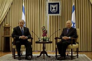 Israel's President Shimon Peres, right, sits with Likud Party leader Benjamin Netanyahu during their meeting at the President's residence in Jerusalem Friday, Feb.20, 2009. Netanyahu of the hawkish Likud Party has received formal permission from Israel's ceremonial president to put together the country's next government. At a ceremony at President Shimon Peres' residence, Netanyahu urged Foreign Minister Tzipi Livni of the governing Kadima Party and Defense Minister Ehud Barak of the Labor Party to join his government.(AP Photo/Dan Balilty)