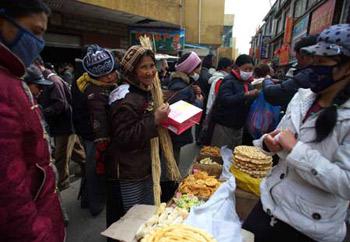 A Tibetan woman buys traditional goods for the Tibetan New Year, at a market in Lhasa, capital of southwest China's Tibet Autonomous Region, Feb. 22, 2009. Traditional goods for the Tibetan New Year are still popular at the market in Lhasa, as the new year draws near. (Xinhua Photo)