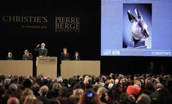 The bronze sculpture of a rabbit's head, which is an ancient Chinese relic, is auctioned in the Grand Palace of Paris in Paris, France, Feb. 25, 2009. Two controversial ancient Chinese relics including the bronze sculptures of a rat's head and a rabbit's head, were auctioned off on Wednesday night for 14 million euros each by anonymous telephone bidders in Christies's sale of the collection of Yves Saint Laurant and Pierre Berge in Paris. The sculptures were looted by invading Anglo-French expedition army in the 19th century, when the invaders burned down the royal garden of Yuanmingyuan in Beijing.(Xinhua/Zhang Yuwei)