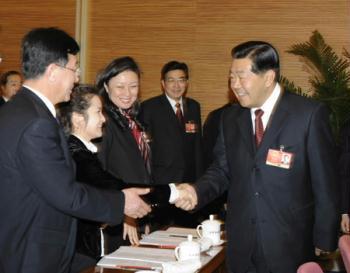 Jia Qinglin (R), member of the Standing Committee of the Political Bureau of the Communist Party of China (CPC) Central Committee and also chairman of the National Committee of the Chinese People's Political Consultative Conference (CPPCC), meets with deputies from Beijing to the Second Session of the 11th National People's Congress (NPC) in Beijing, capital of China, March 5, 2009. Jia Qinglin joined in the panel discussion of Beijing delegation on the opening day of the Second Session of the 11th NPC. (Xinhua/Chen Shugen)