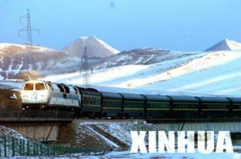 Photo taken on Nov. 25, 2006 shows a train roars on the Qinghai-Tibet Railway at the Kunlun Mountains area in Qinghai. The 1,956-km Qinghai-Tibet railway starts from Xining, capital of northwest China's Qinghai Province, and ends in Lhasa. It is the world's highest railway and the first railway ever to go to Tibet.(Xinhua Photo)