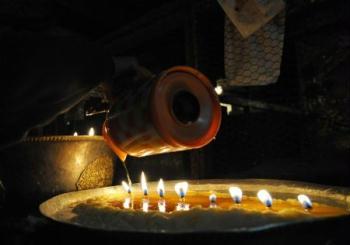 A believer adds ghee to the lamp in the Jokhang Temple in Lhasa, capital of southwest China's Tibet Autonomous Region, Mar. 11, 2009. A celebration for the ghee flowers and lanterns festival was held in the Jokhang Temple, attracting the visitors from all over the nation. (Xinhua/Chogo)