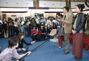 Zhang Yun (R2) and Degyi Zhoema (R1), researchers of the Tibetology Research Center of China, answer questions from foreign correspondents at the "50th Anniversary of Democratic Reforms in Tibet" Exhibition in Beijing, capital of China, March 18, 2009. A number of foreign journalists, organized by the Information Department of China's Foreign Ministry, visited the exhibition on Wednesday. (Xinhua/Li Mingfang)