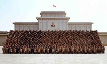 Top leader Kim Jong-il (front row C) of the Democratic People's Republic of Korea (DPRK) poses for a group photo with soldiers in Pyongyang in this undated picture released by the Korean Central News Agency (KCNA) on March 21, 2009.(Xinhua/KCNA)